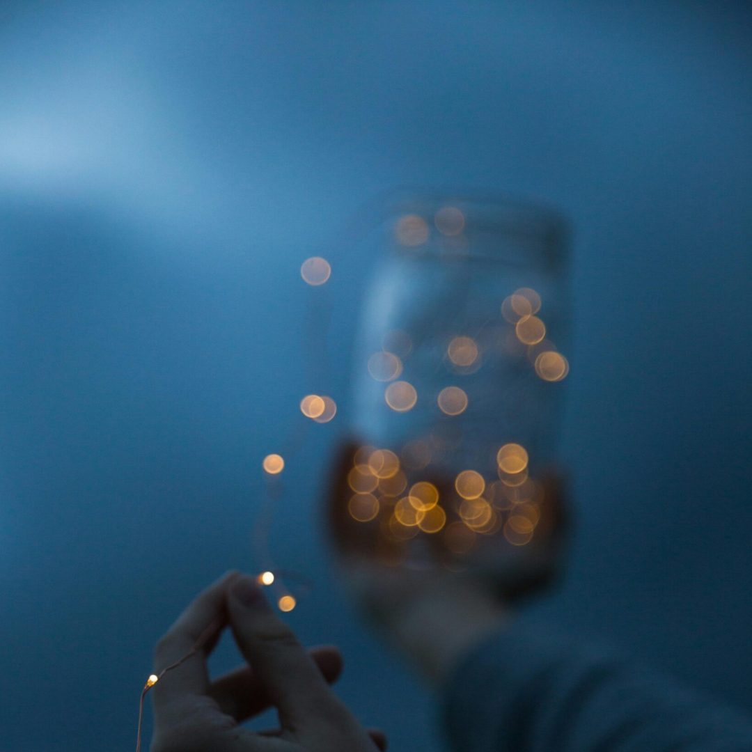 pexels-photo-3378993-3378993 Hands holding a jar with glowing lights, creating a magical atmosphere at night.
